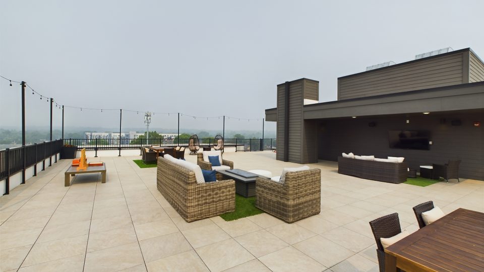 a rooftop patio with a large table and chairs at The River House