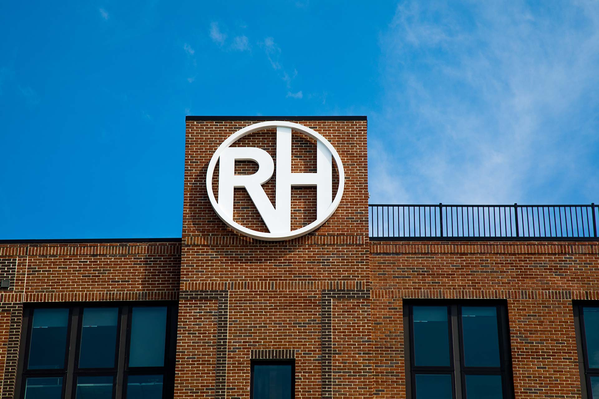 rh logo on a brick building at The River House