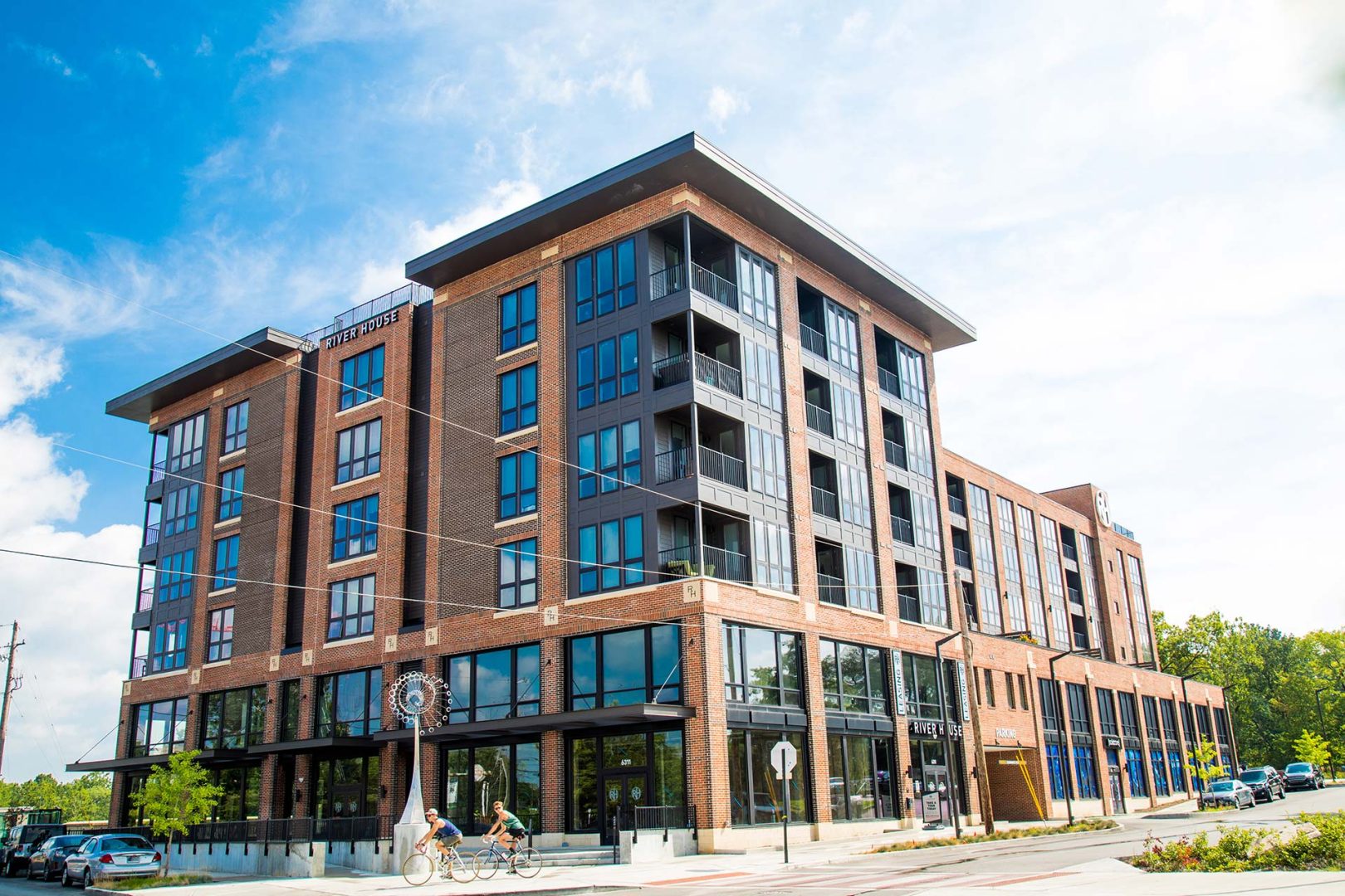 a large apartment building with windows on the side at The River House