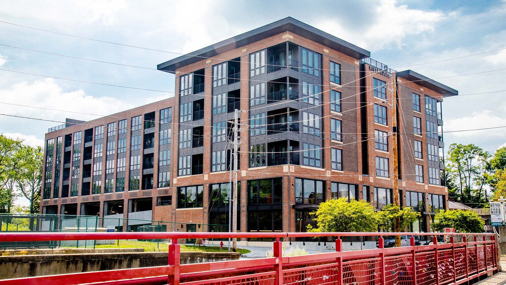 a large apartment building with a red railing at The River House