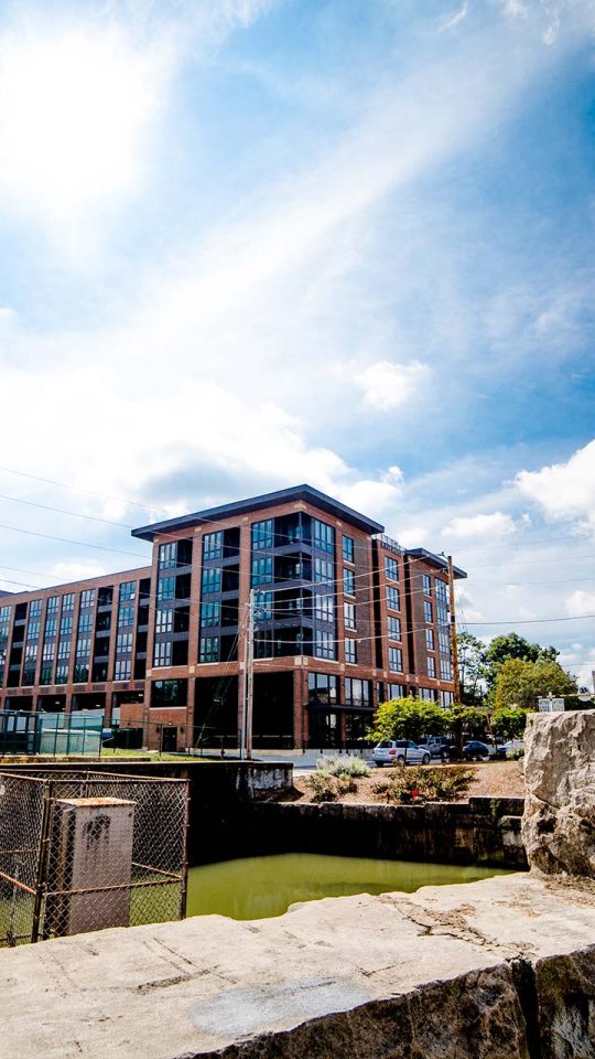 a large building is seen in the distance at The River House