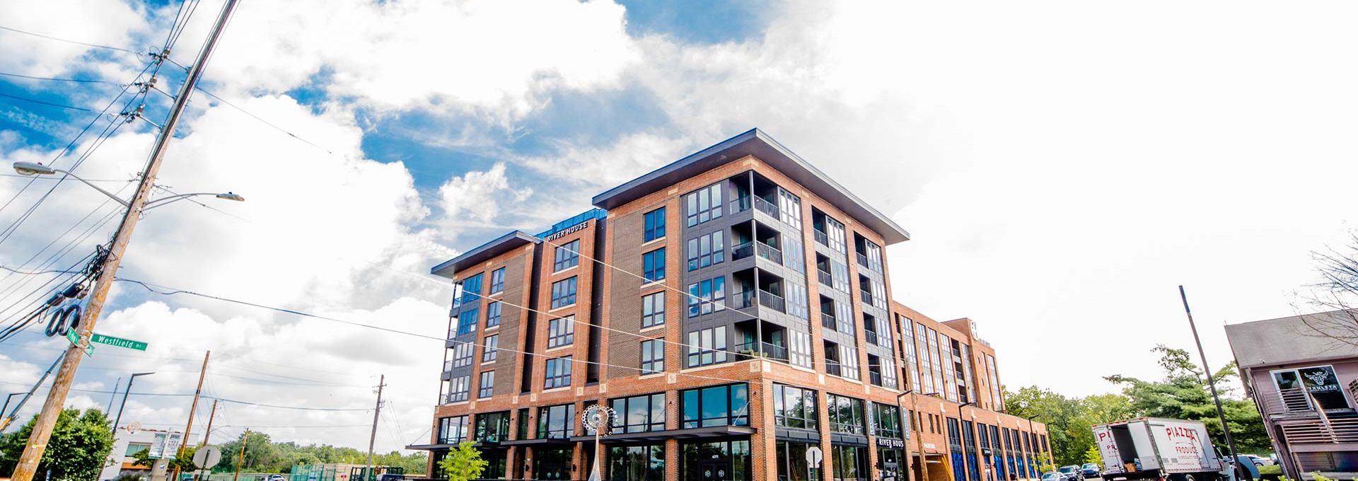 a large apartment building on a corner street at The River House