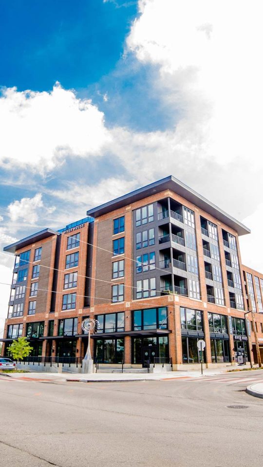 a large apartment building on a corner street at The River House