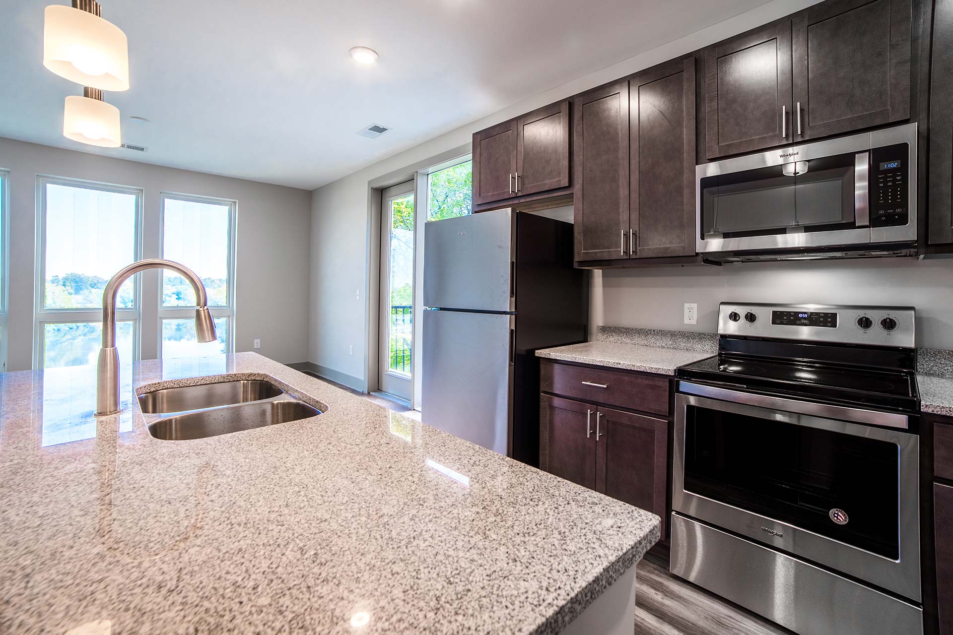 kitchen with granite counter tops and stainless steel appliances at The River House