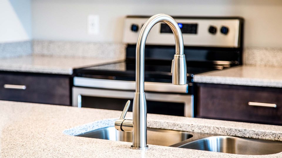 a kitchen sink with a stainless steel faucet at The River House