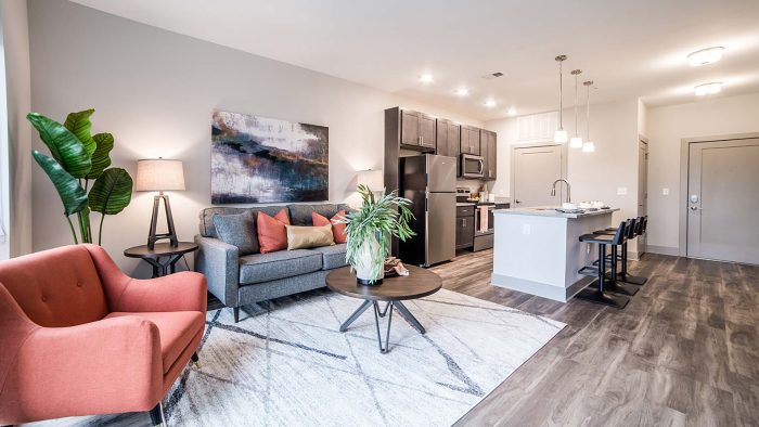 the living room and kitchen area of a new apartment at The River House